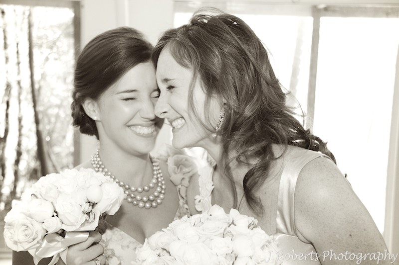 Bride laughing with her bridesmaid - wedding photography sydney